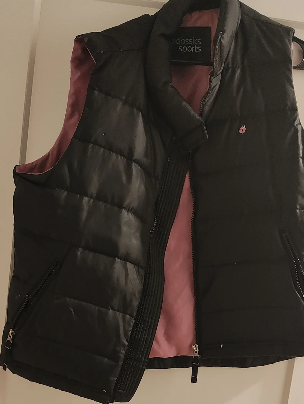Women's Black Puffer Vest with Pink Lining.